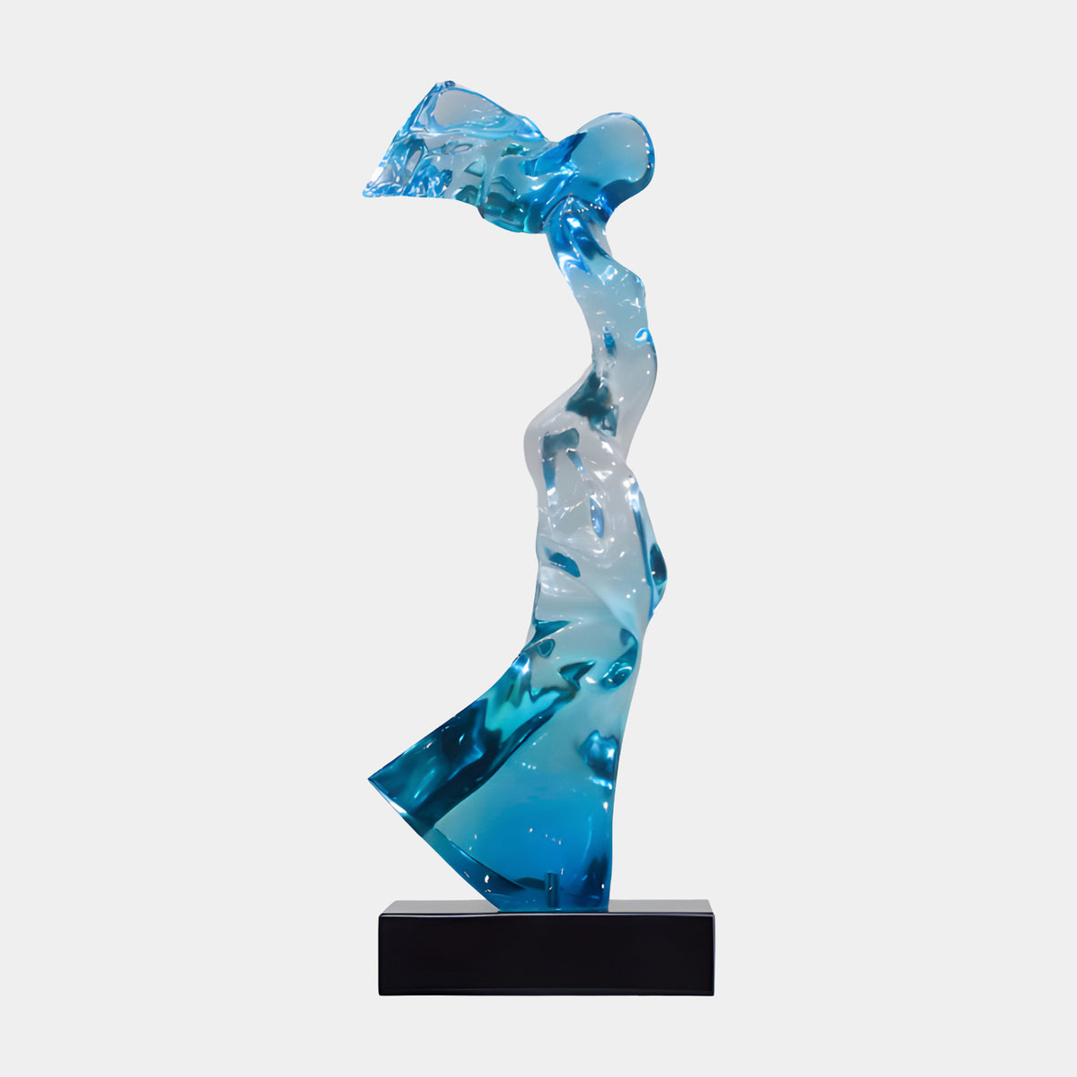 Aqua & Clear Windblown Figure Resin Sculpture, 68cm, with rippled wind-blown form and flared skirt base, on a black marble block, plain white background.