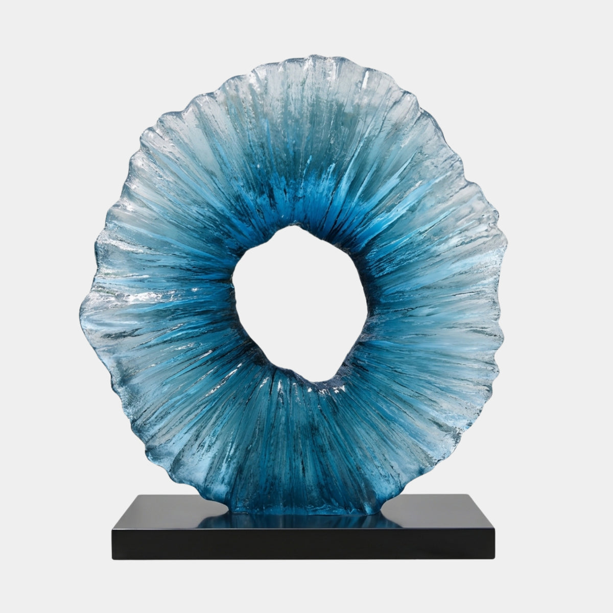 Blue Rayed Disc Resin Sculpture - 101cm, a ringed disc with off-centre opening and ray-textured face, deep blue fading to pale edges, on a black marble base against a plain white background.