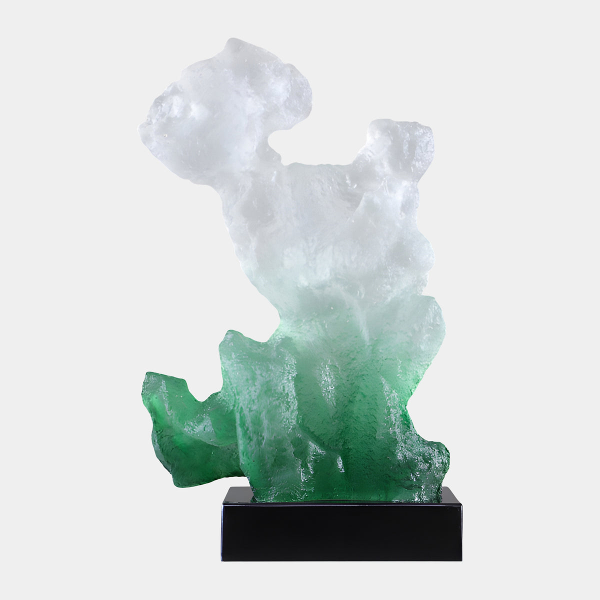 Green & White Eroded Rock Resin Sculpture (56cm) by Giant Sculptures, an eroded rock-form piece shading from green at the base to white at the top, set on a black marble block against a plain light background.