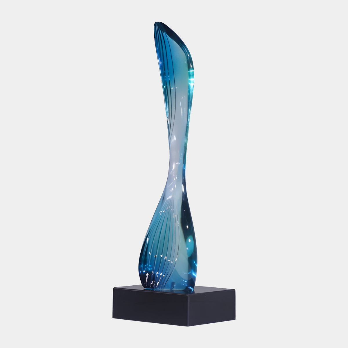 Blue & Clear Waisted Column Resin Sculpture - 59cm, a twisting hourglass-shaped form with fine linear detailing on a black block base, set against a plain light background.