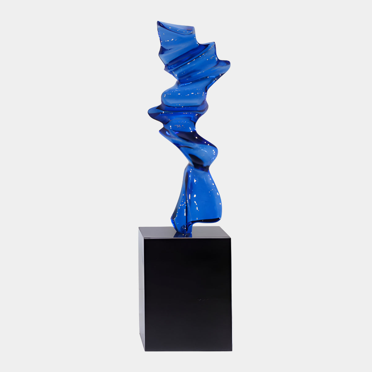 Blue Folded Band Resin Sculpture - 115cm, a twisting deep blue folded form on a black marble plinth, shown against a plain light background.