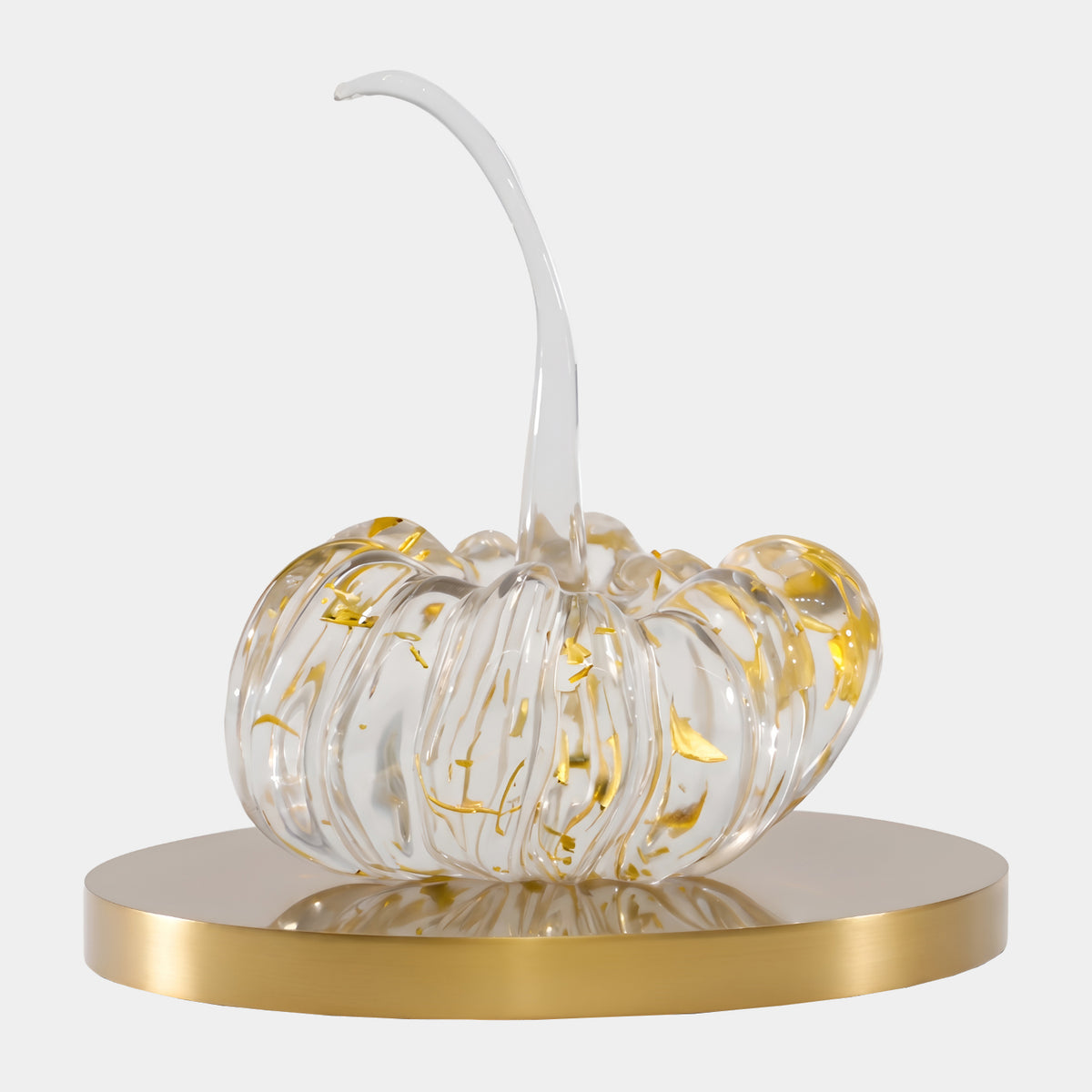 Clear Gold Leaf Pumpkin Resin Sculpture, 25cm, with ribbed body, gold leaf flecks, and curved stem on a brushed gold steel disc, shown against a plain light background.