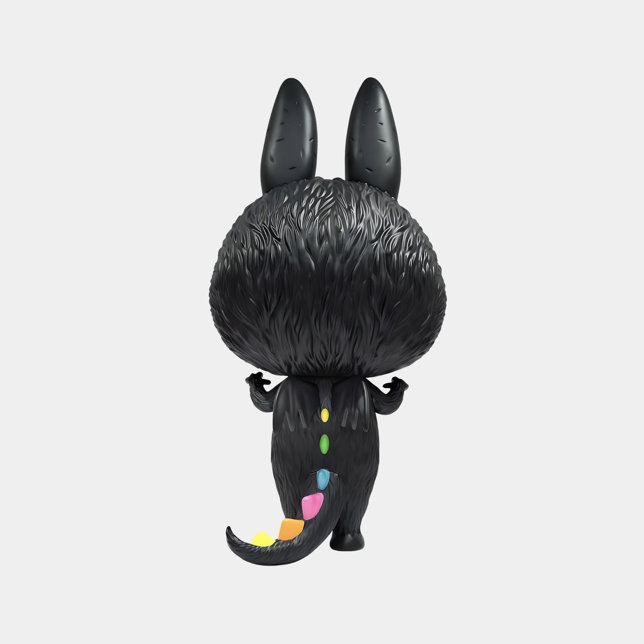The Monster Zimomo Titan Labubu Sculpture (70cm) by Giant Sculptures features a black, furry figure with large upright ears and a tail adorned in vibrant yellow, pink, green, and blue geometric patterns—perfect for playful modern decor.