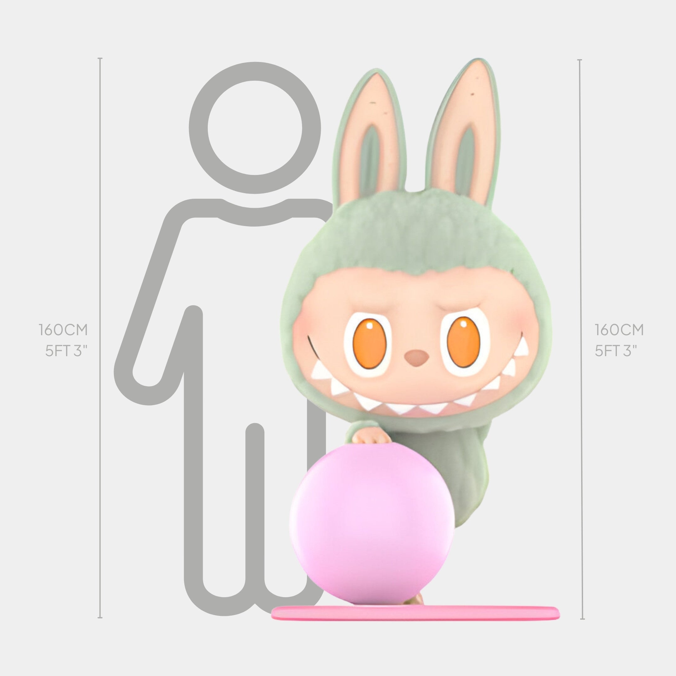 The Lazy Yoga Zone Out Labubu Sculpture - 160cm by Giant Sculptures features a cartoon figure in a green bunny suit holding a pink ball on a pink base. Ideal for indoor display, it stands before a gray human outline with height markers at 160 cm (5 ft 3 in).