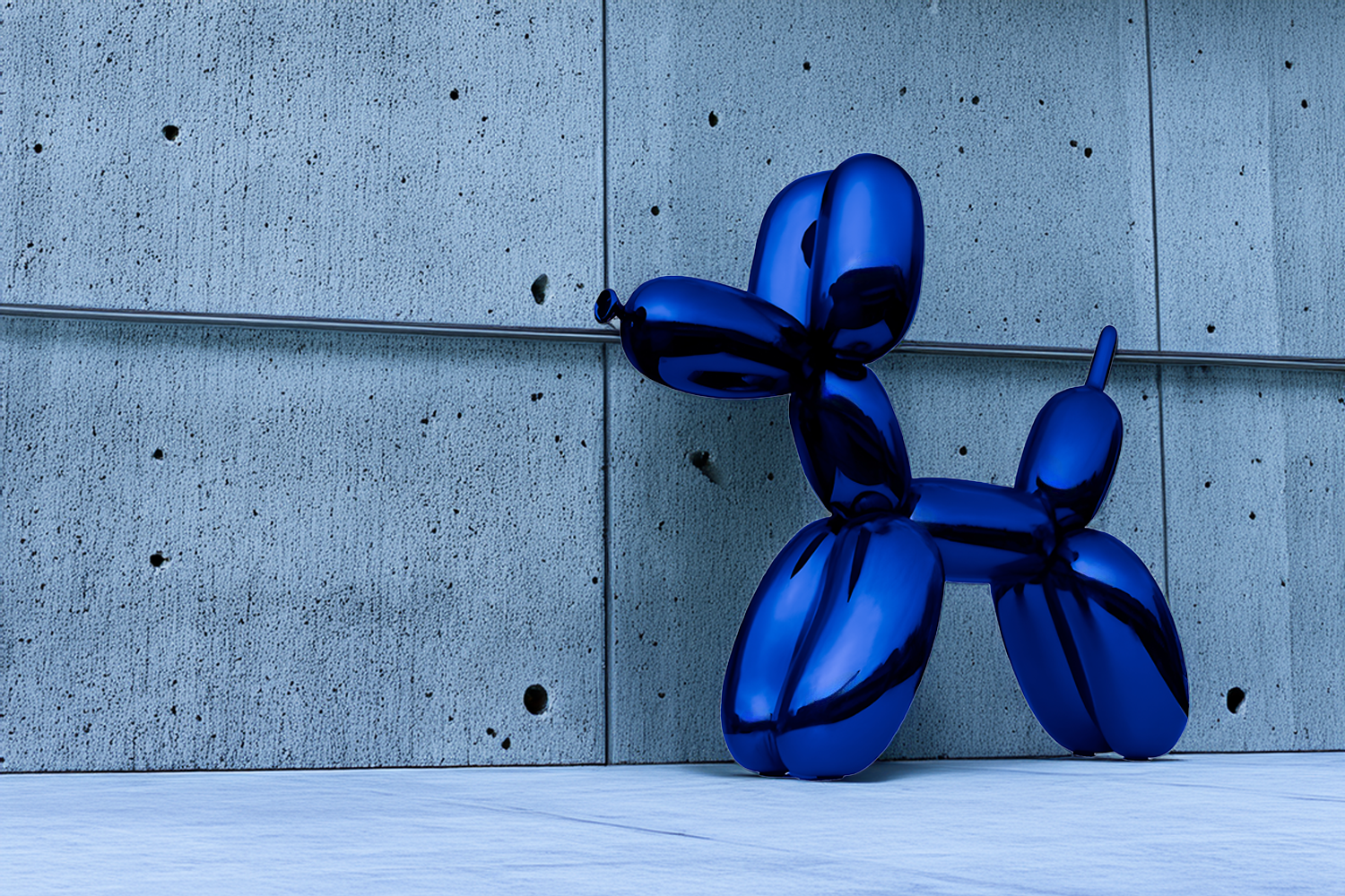 A large, shiny blue balloon sculpture resembling a dog leans against a minimalist concrete wall. The setting is a modern, open space with a smooth floor and textured wall backdrop.