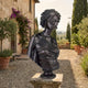 Classical African Woman Bronze Bust 70cm by Giant Sculptures with dark patina, displayed on a stone plinth in a Tuscan courtyard with olive trees and cypresses.