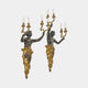 Pair of Giant Sculptures Classical Figural Torso Wall Sconces in dark patinated bronze with gilded drapery and three-arm candelabra, shown on a plain background.