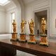 Giant Sculptures Classical Four Seasons Goddesses 40cm gilded bronze set on sienna and green marble plinths, displayed on a wooden table in a gallery interior.