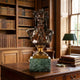 Classical Laureate Male Bust Bronze Bust by Giant Sculptures on a green marble plinth, displayed on a wooden desk in a library with bookshelves and a lamp.