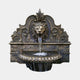 Giant Sculptures' 130cm Classical Lion Head Wall Fountain in cast bronze with antique patina, baroque backplate, acanthus scrollwork, and gadrooned basin catching water.