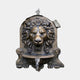 Classical Lion Head Wall Fountain Bronze Sculpture by Giant Sculptures, 110cm, with water spouting from the lion's mouth into a ribbed shell basin on a plain background.