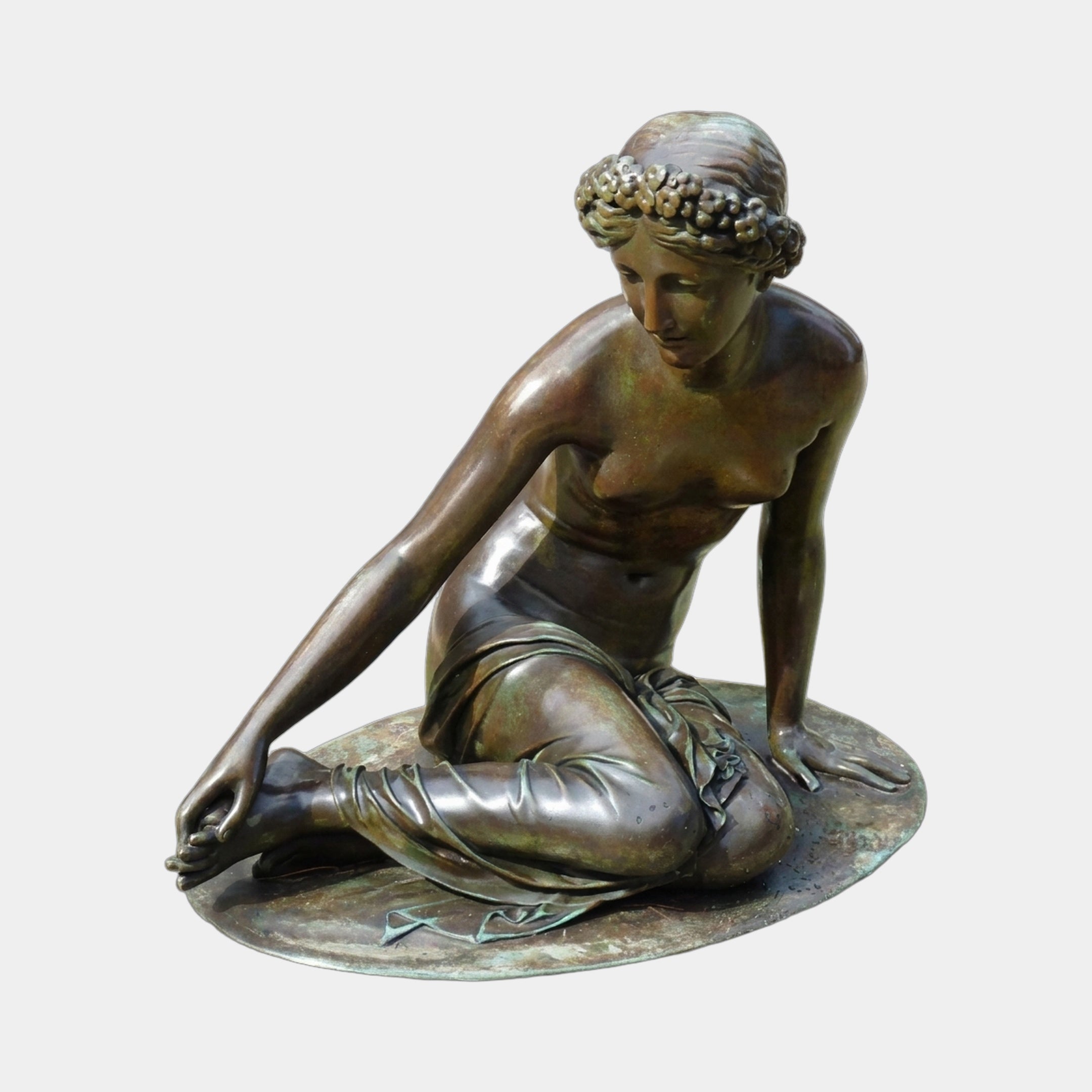 Classical Semi-Reclined Nude Female Bronze Fountain Sculpture by Giant Sculptures, seated figure with laurel wreath and warm brown verdigris patina on circular plinth.