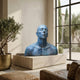 Contemporary Contemplative Male Bust by Giant Sculptures with blue-green patina on a travertine plinth in a sunlit room with olive tree and tall windows.