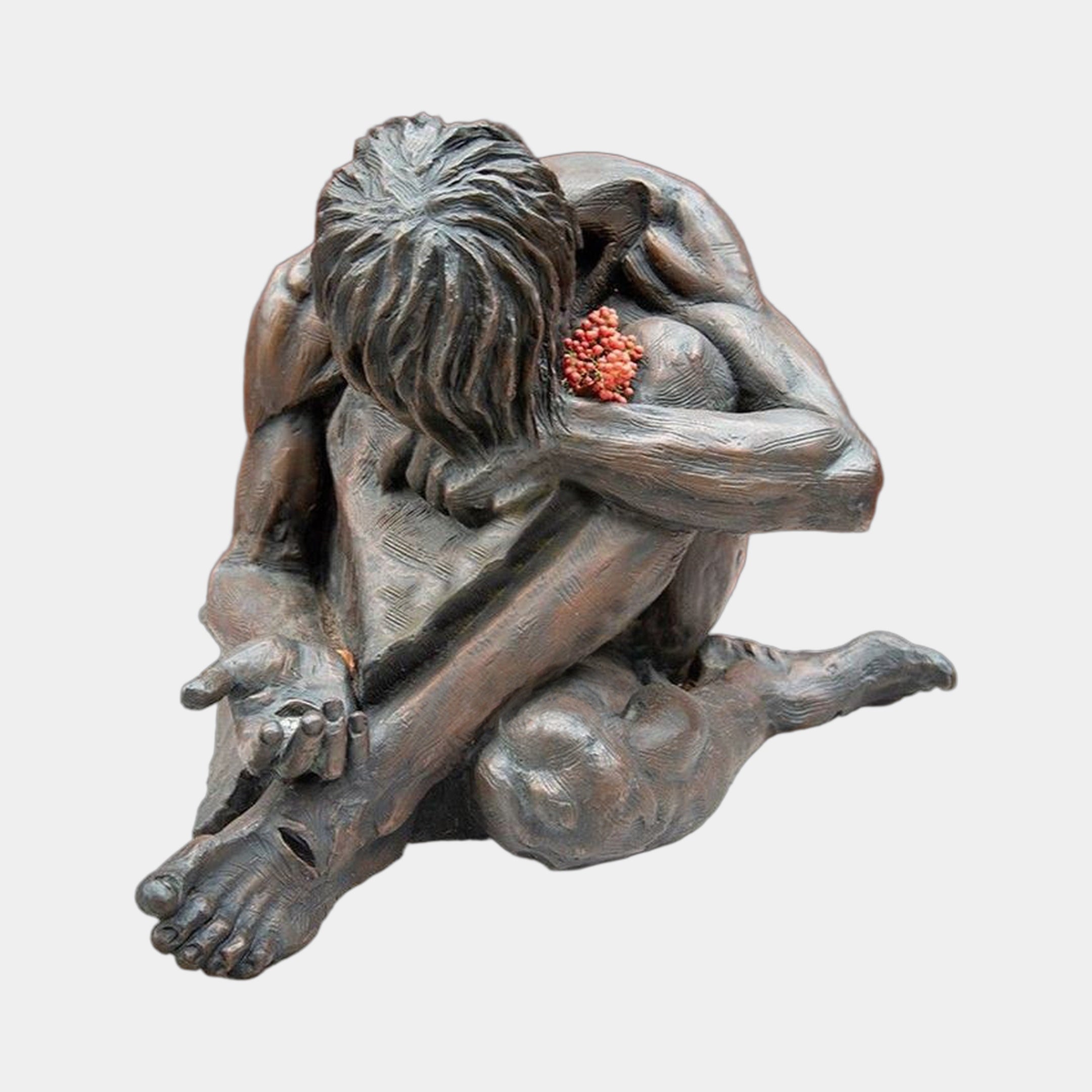 Contemporary Crouching Figure Bronze Sculpture by Giant Sculptures, 150cm dark-patina figure curled with head bowed on folded arms, holding red flowers, on grey.