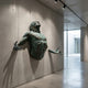 Giant Sculptures Contemporary Emerging Male Figure Bronze Relief 60cm, verdigris green torso with head back and arms outstretched, mounted on a concrete gallery wall.