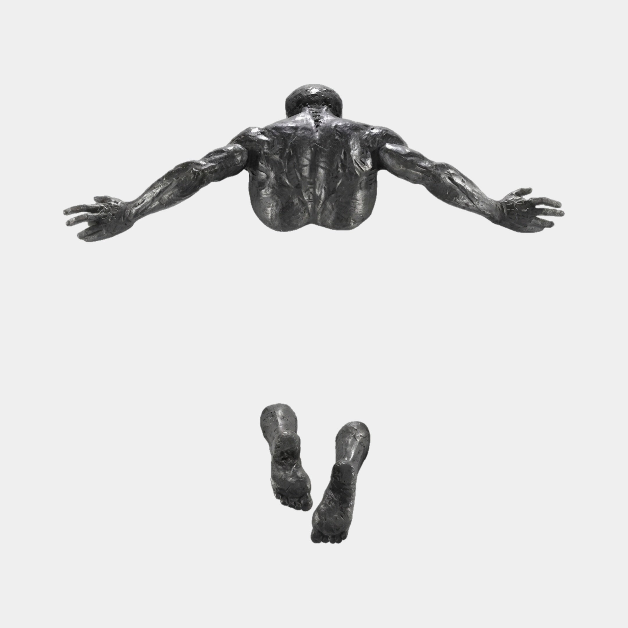 Giant Sculptures Contemporary Emerging Male Figure 60cm bronze wall sculpture in dark pewter tone, showing muscular back, outstretched arms, and separate feet below.