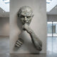Contemporary Emerging Male Figure Bronze Wall Sculpture by Giant Sculptures, furrowed face with fist to chin and lower clenched fist emerging from a gallery wall.