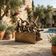 Contemporary Five Rabbit Bronze Sculpture by Giant Sculptures on a stone patio beside a pool, five linked rabbits in warm brown patina on a rectangular plinth.