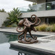 Contemporary Octopus Bronze Sculpture by Giant Sculptures, 80cm, displayed on a stone poolside terrace beside a modern concrete house with tropical planting.