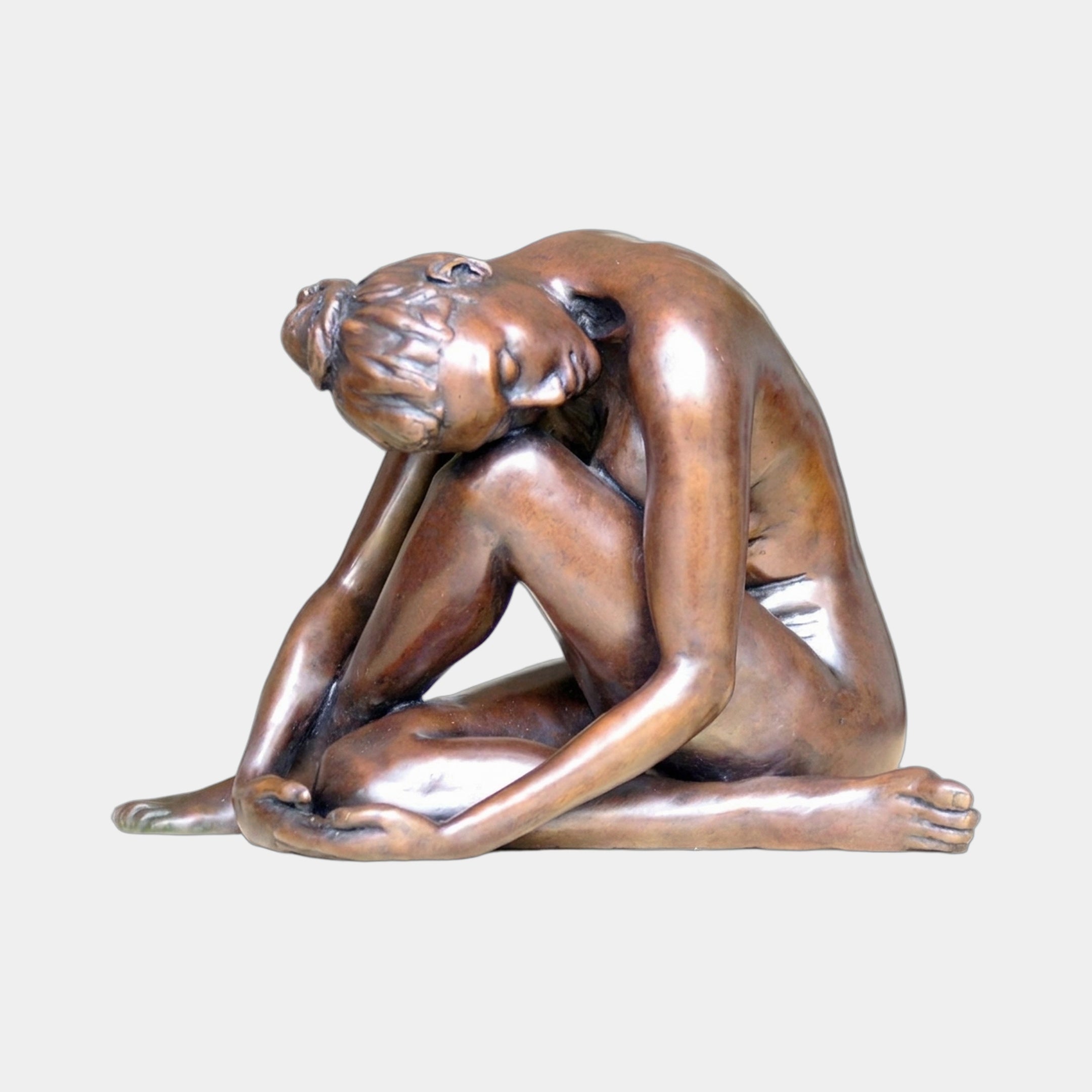 Contemporary Seated Nude Female Figure Bronze Sculpture by Giant Sculptures, shown in side profile with head bowed to knees and warm reddish-brown patina.