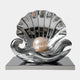 The Cradle Silver Shell Steel Sculpture - 200cm by Giant Sculptures features a striking open seashell with a glossy pearl on a reflective rectangular base, combining wave-like curves and polished surfaces for a bold contemporary statement.