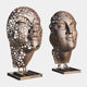 Giant Sculptures Contemporary Perforated Heads Bronze Sculpture 220cm, two closed-eye faces with ribbed layers and circular cutouts on slim pedestal bases.