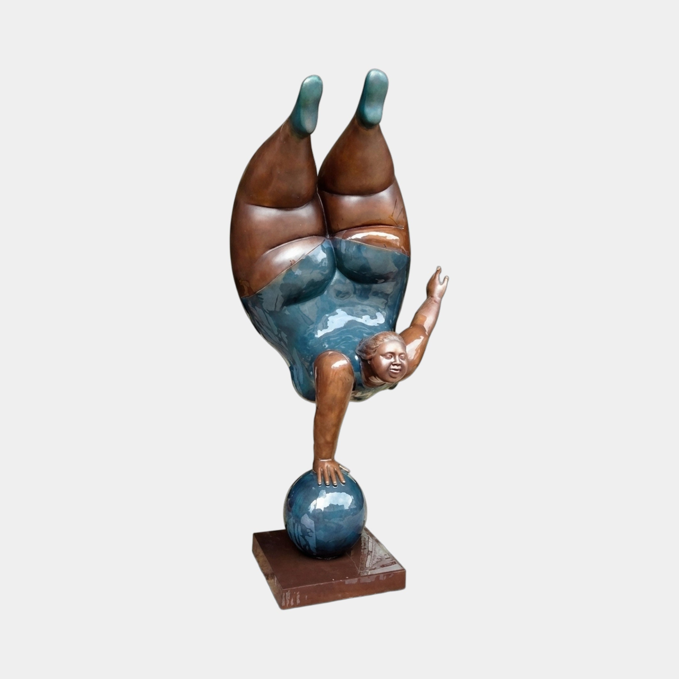Giant Sculptures' 220cm Contemporary Rotund Figure Handstand Bronze Sculpture showing an inverted female figure balancing on a teal sphere, with warm brown skin and turquoise swimsuit patina, on a square base against a plain background.