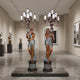 Large Classical Candelabra Torchiere Figure Bronze Sculpture by Giant Sculptures, pair of 220cm draped female figures with two-tone patina, displayed in a gallery.