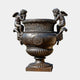Large Classical Cherub Urn Bronze Sculpture by Giant Sculptures, 150cm Medici-style urn with two winged cherub handles, dark patina, on plain background.