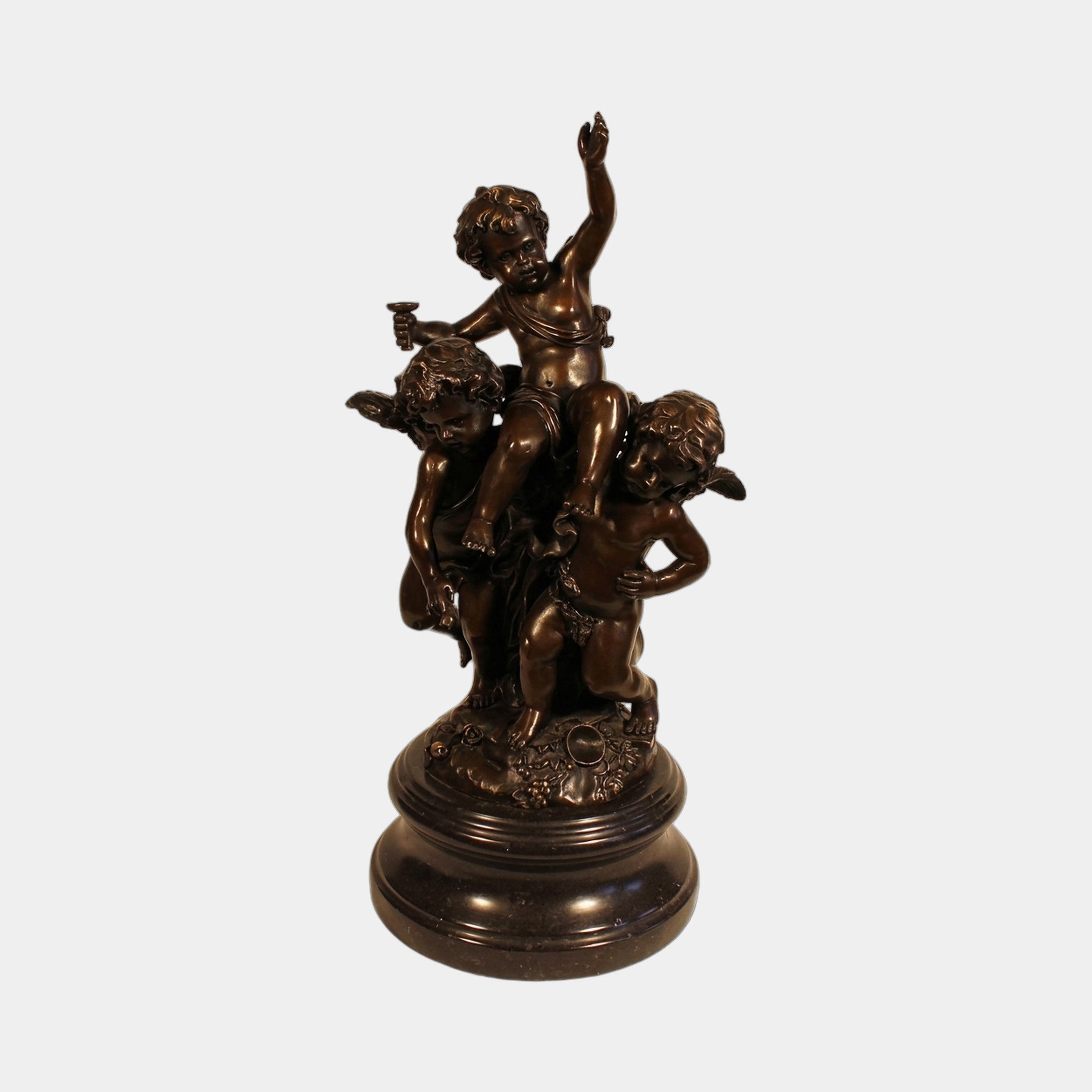 Large Classical Cherubs and Central Figure Bronze Sculpture by Giant Sculptures, with a child raising one arm flanked by two winged cherubs on a round base.