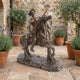 Large Classical Don Quixote on Rearing Horse Bronze Sculpture by Giant Sculptures displayed on a stone courtyard with lavender pots and olive trees.