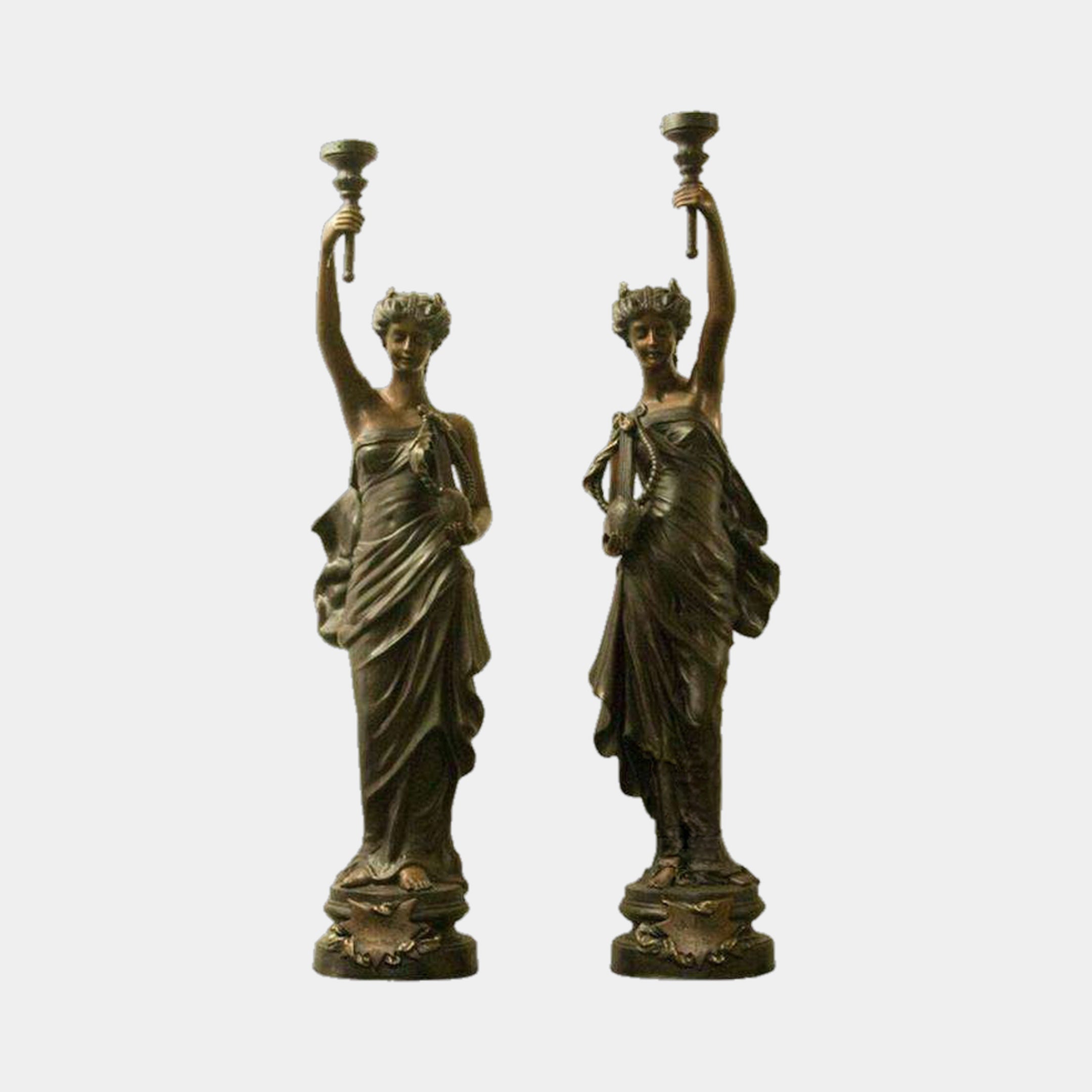 Large Classical Goddess Pair Bronze Sculpture by Giant Sculptures, 180cm, two draped female figures raising candelabra torchères on round bases, against a plain background.