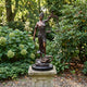 Large Classical Lady Justice Bronze Statue by Giant Sculptures on a stone plinth in a garden, holding scales and sword above a serpent and books.
