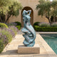 Large Classical Reclining Mermaid Bronze Sculpture by Giant Sculptures with verdigris patina, displayed on a stone plinth beside a poolside lavender garden.