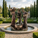 Large Classical Three Draped Figures Fountain by Giant Sculptures in warm brown bronze, three robed women pouring vessels into a central basin in a formal garden.