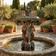 Large Classical Three Graces Fountain Bronze Sculpture by Giant Sculptures, 280cm, three bronze figures supporting a verdigris tiered basin in a Mediterranean garden courtyard with lavender and olive trees.
