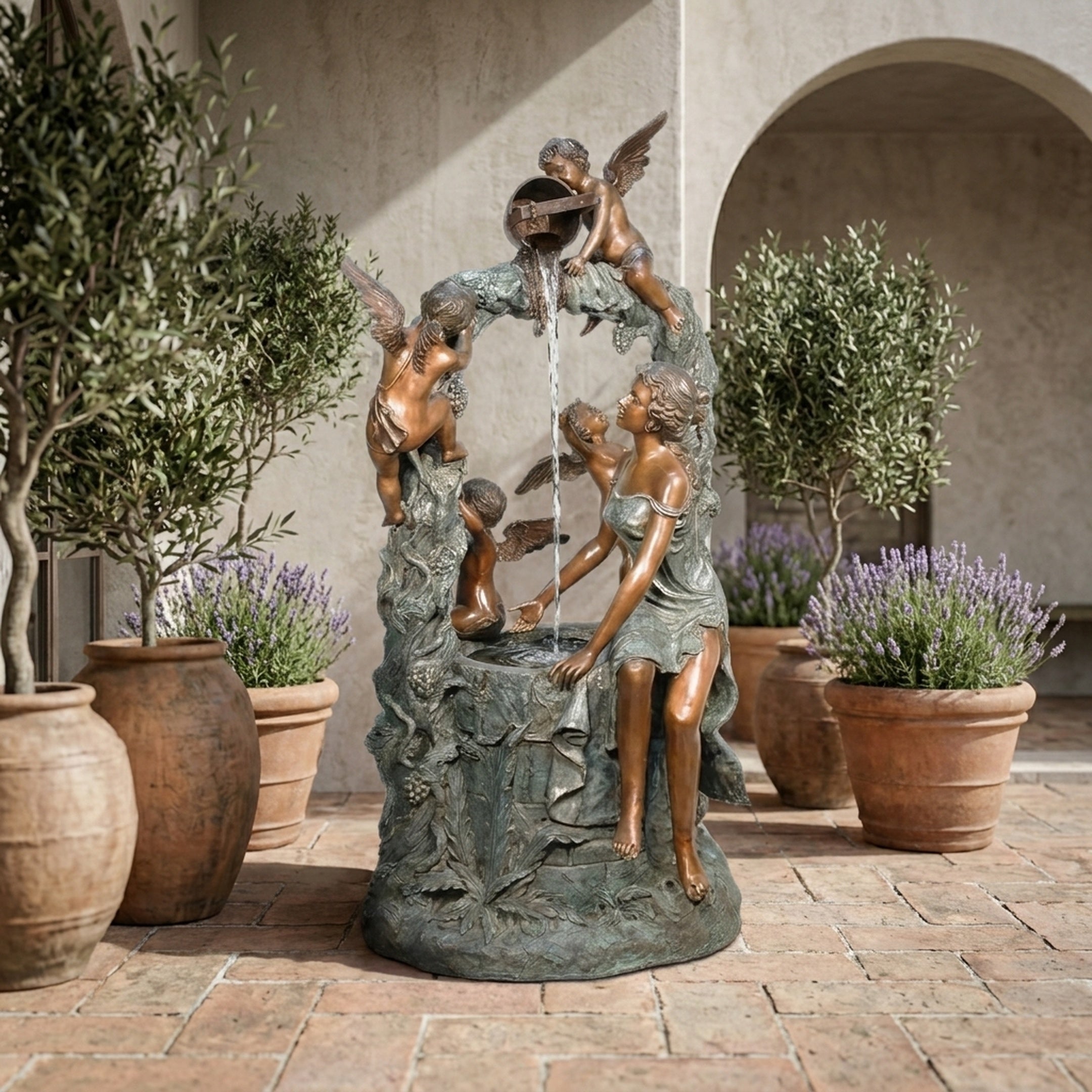 Giant Sculptures' Large Classical Woman and Cherubs Bronze Fountain 150cm with verdigris base in a Mediterranean courtyard framed by olive trees and lavender pots.