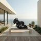 Giant Sculptures' 120cm Large Contemporary Abstract Reclining Figure Bronze Sculpture in black patina on a stone plinth, displayed on a modern oceanview terrace.