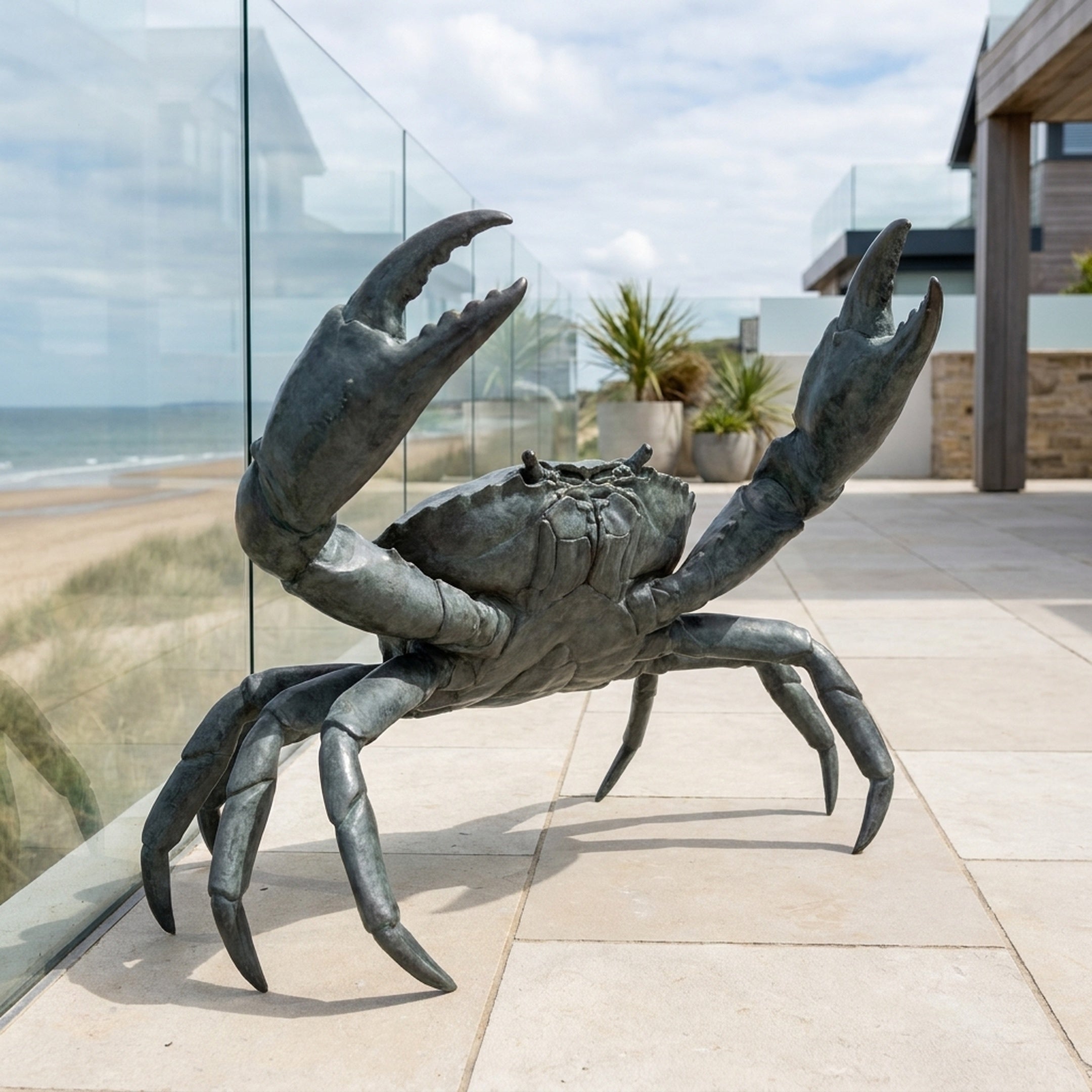 Large Contemporary Crab Bronze Sculpture by Giant Sculptures, 150cm tall with both claws raised, dark grey-green patina, on a coastal terrace beside the sea.
