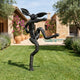 Large Contemporary Dancing Hare Bronze Sculpture by Giant Sculptures, 150cm black matte figure mid-leap on a lawn beside a stone villa and pool.