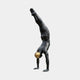 Large Contemporary Handstanding Male Figure Bronze Sculpture by Giant Sculptures, 240cm, dark patina, polished gold sphere between thighs, plain background.