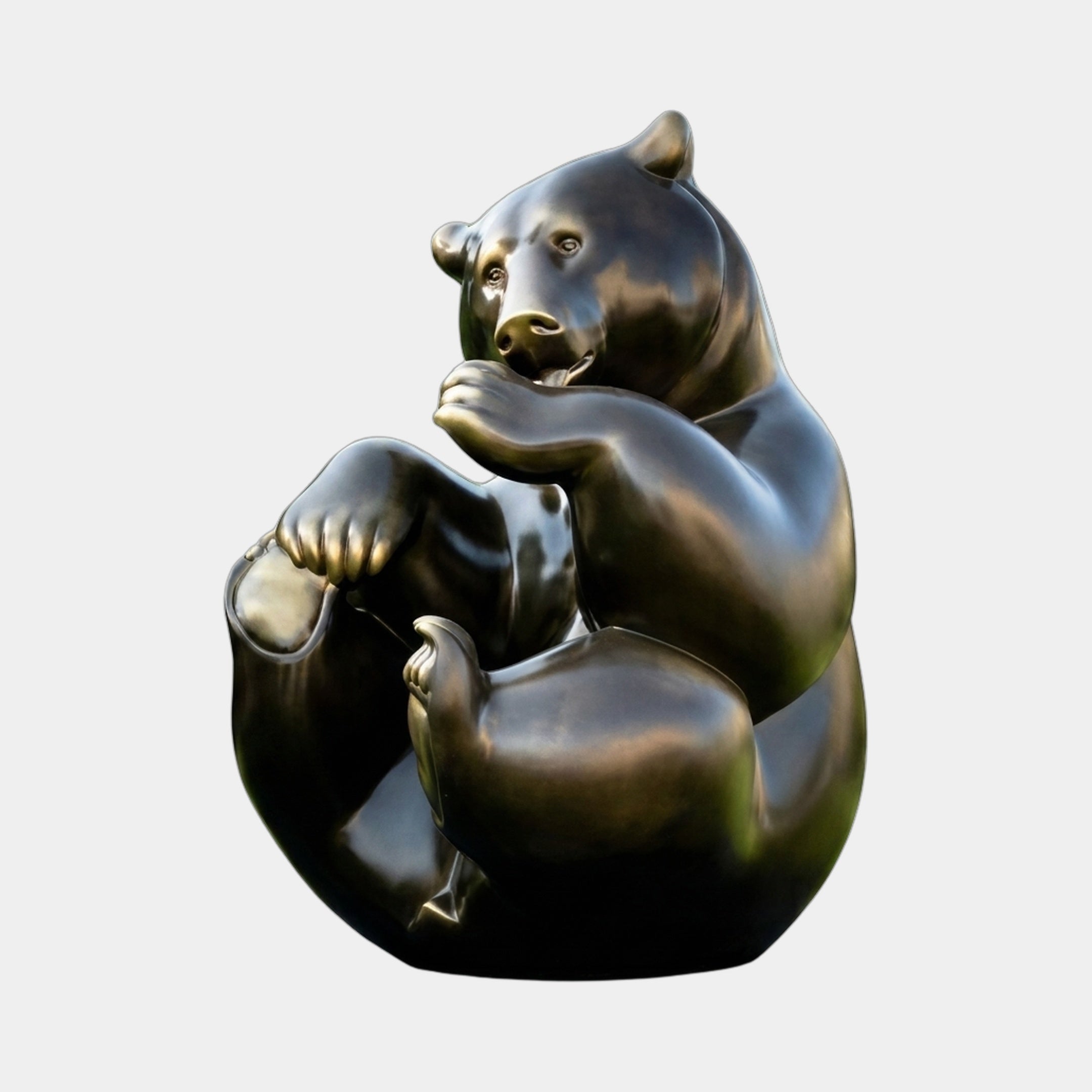 Large Contemporary Seated Bear Bronze Sculpture by Giant Sculptures, shown in a rounded seated pose with paw raised, dark patina and golden highlights.