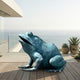 Large Contemporary Seated Frog Bronze Sculpture by Giant Sculptures with verdigris patina, mouth open skyward, on a seaside terrace beside succulents.