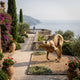 Large Contemporary Stalking Cheetah Bronze Sculpture by Giant Sculptures in a clifftop Mediterranean garden with bougainvillea, cypress trees, and sea views.