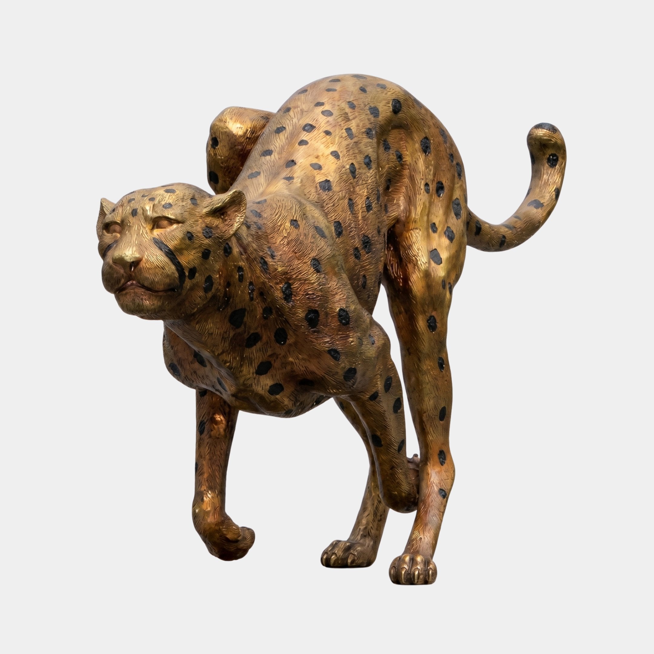 Large Contemporary Stalking Cheetah Bronze Sculpture by Giant Sculptures in a crouched stance with golden-bronze patina and black spots, on a plain background.