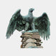 Giant Sculptures Large Heraldic Eagle Bronze Sculpture 150cm with wings spread wide and verdigris patina, perched on a stacked stone column against a light grey background.