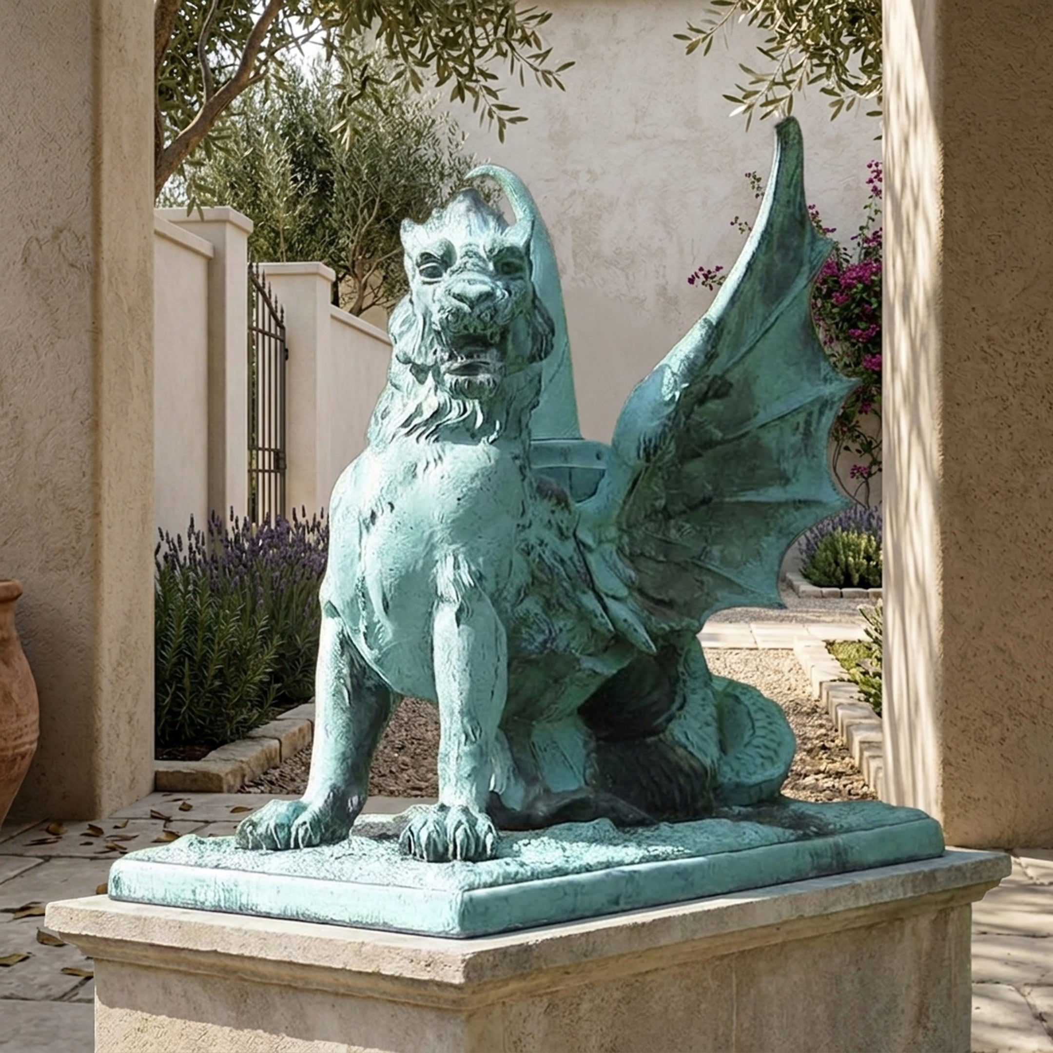 Large Heraldic Winged Lion-Dragon Gargoyle Bronze Sculpture by Giant Sculptures with verdigris patina, displayed on a stone plinth in a Mediterranean courtyard.