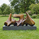 Large Modern Abstract Bronze Sculpture by Giant Sculptures, three interlocking biomorphic forms in warm brown patina on a slate-effect plinth in a garden lawn.