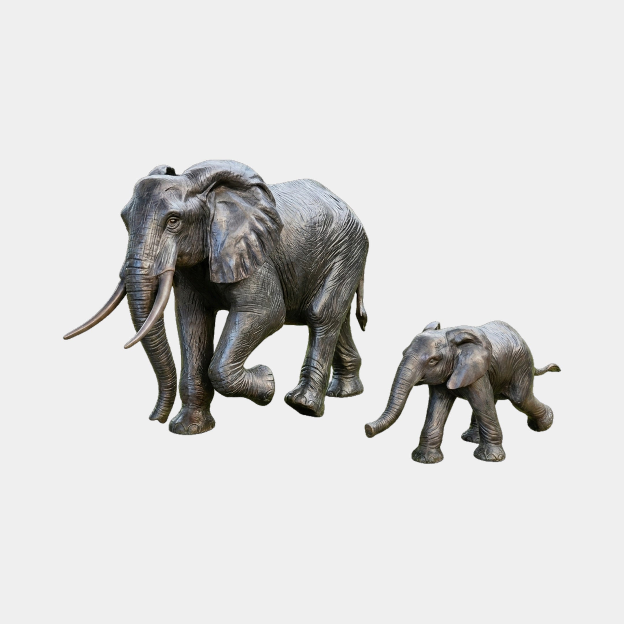 Large Traditional Adult and Baby Elephant Bronze Sculpture by Giant Sculptures, adult mid-stride with long tusks beside a following calf, charcoal patina.