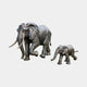 Large Traditional Adult and Baby Elephant Bronze Sculpture by Giant Sculptures, adult mid-stride with long tusks beside a following calf, charcoal patina.